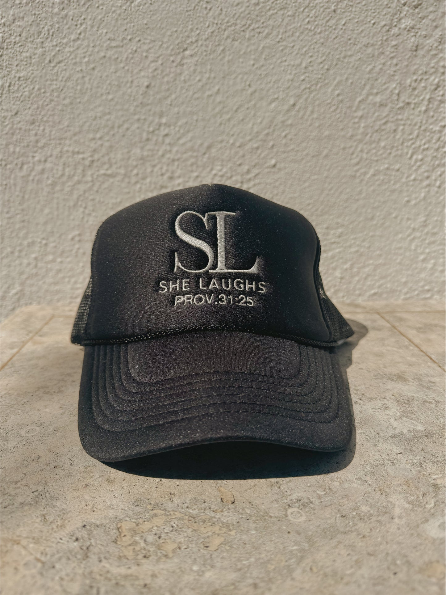 She Laughs Trucker Hat